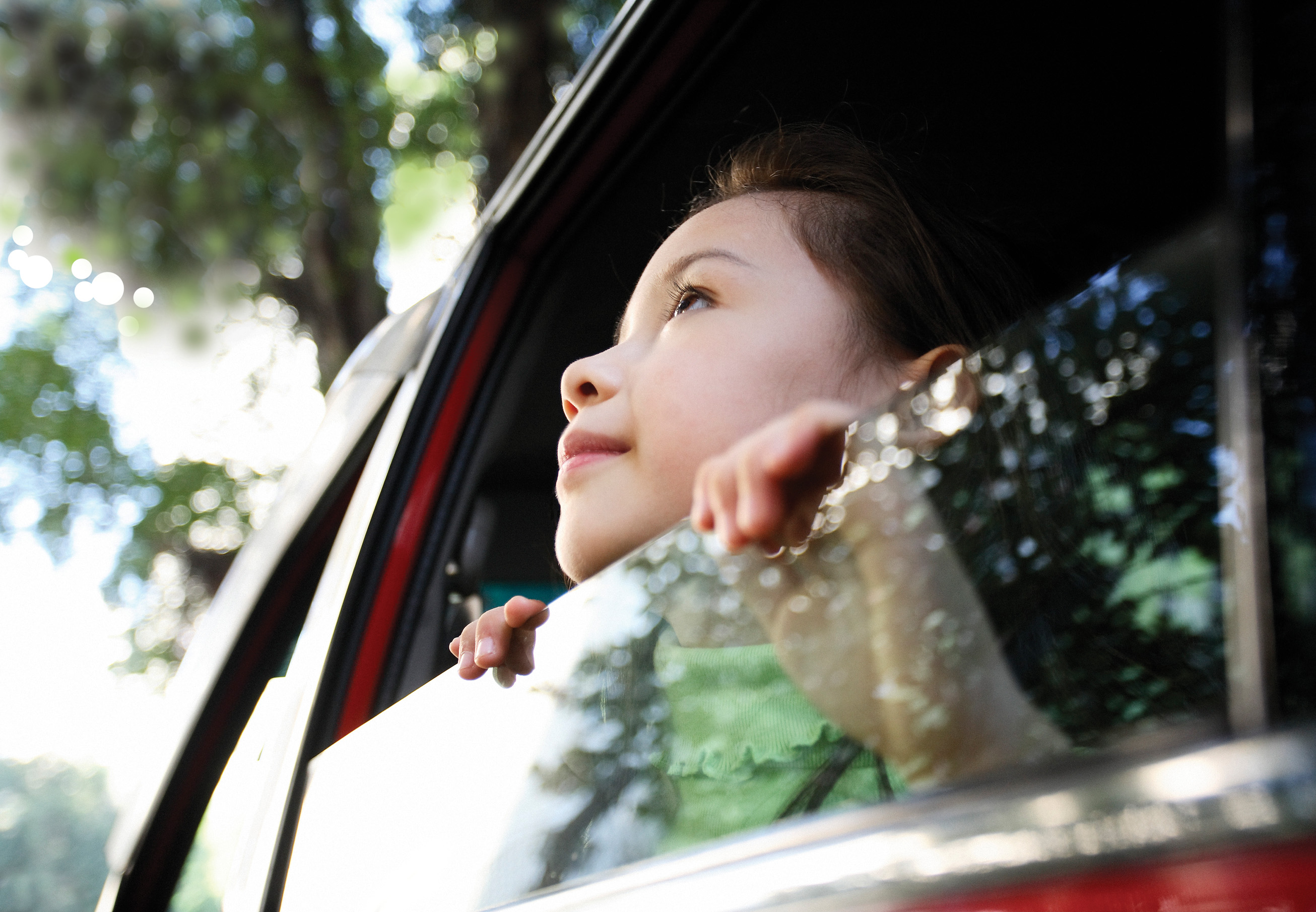 Girl out of car window